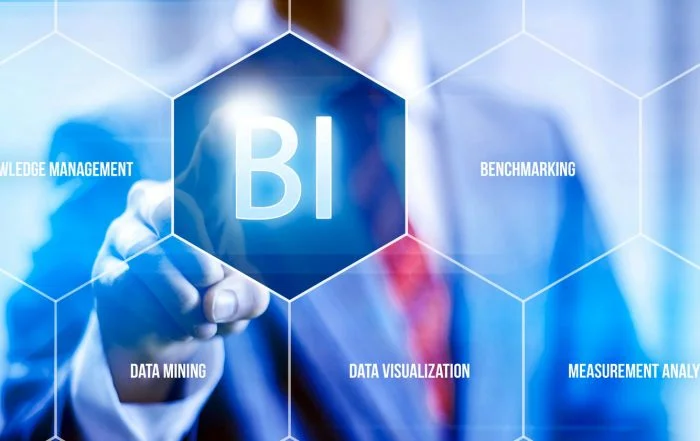 Man pressing a virtual business intelligence button on a glass panel in front of him. Very science fictionesque